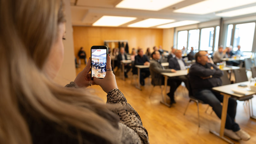 Teilnehmerin filmt Seminarveranstaltung mit dem Smartphone – Konferenzfotografie Erfurt